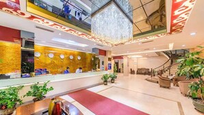 A hotel lobby with a reception desk, clocks, a chandelier, and a staircase. - Kaiserdom Hotel Airport Branch (Guangzhou)