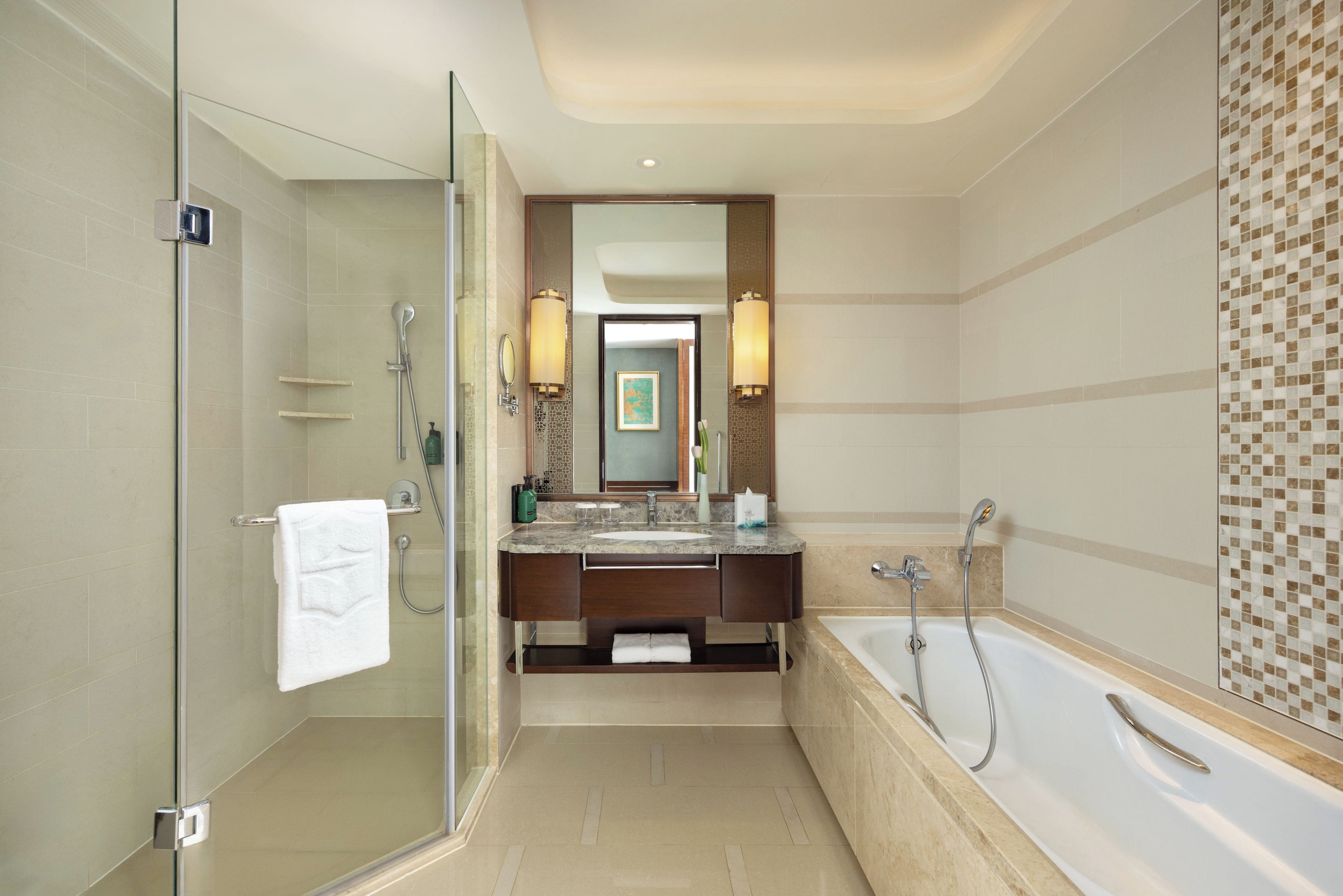 A modern bathroom with a glass shower enclosure, a bathtub, and a vanity with a mirror.