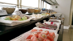 A buffet with various food items including pastries, nuts, and other snacks. - Blue Garden Hotel (Konyaalti)