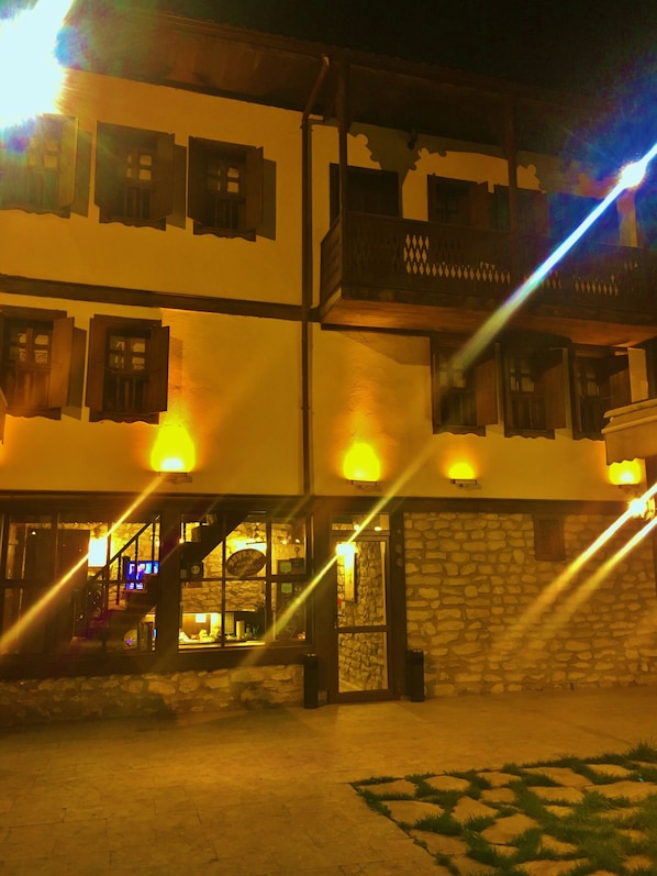 A multi-story building with a stone facade and wooden balconies.