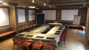 A conference room with long tables, chairs, and a projector screen. - Weinstadt-Hotel (Weinstadt)