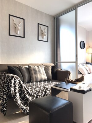 1-Bedroom Condo | Living area | 32-inch flat-screen TV with cable channels, TV, iPod dock