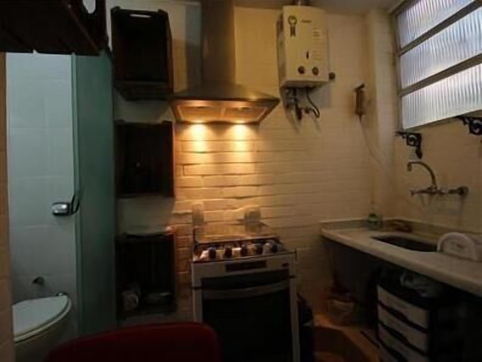 A compact kitchen with a stove, oven, and a small sink.