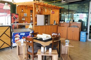 A restaurant with wooden decor, a Coca-Cola fridge, and a sign for 'KASA'. - Kule Hotel & Spa (Gaziantep)