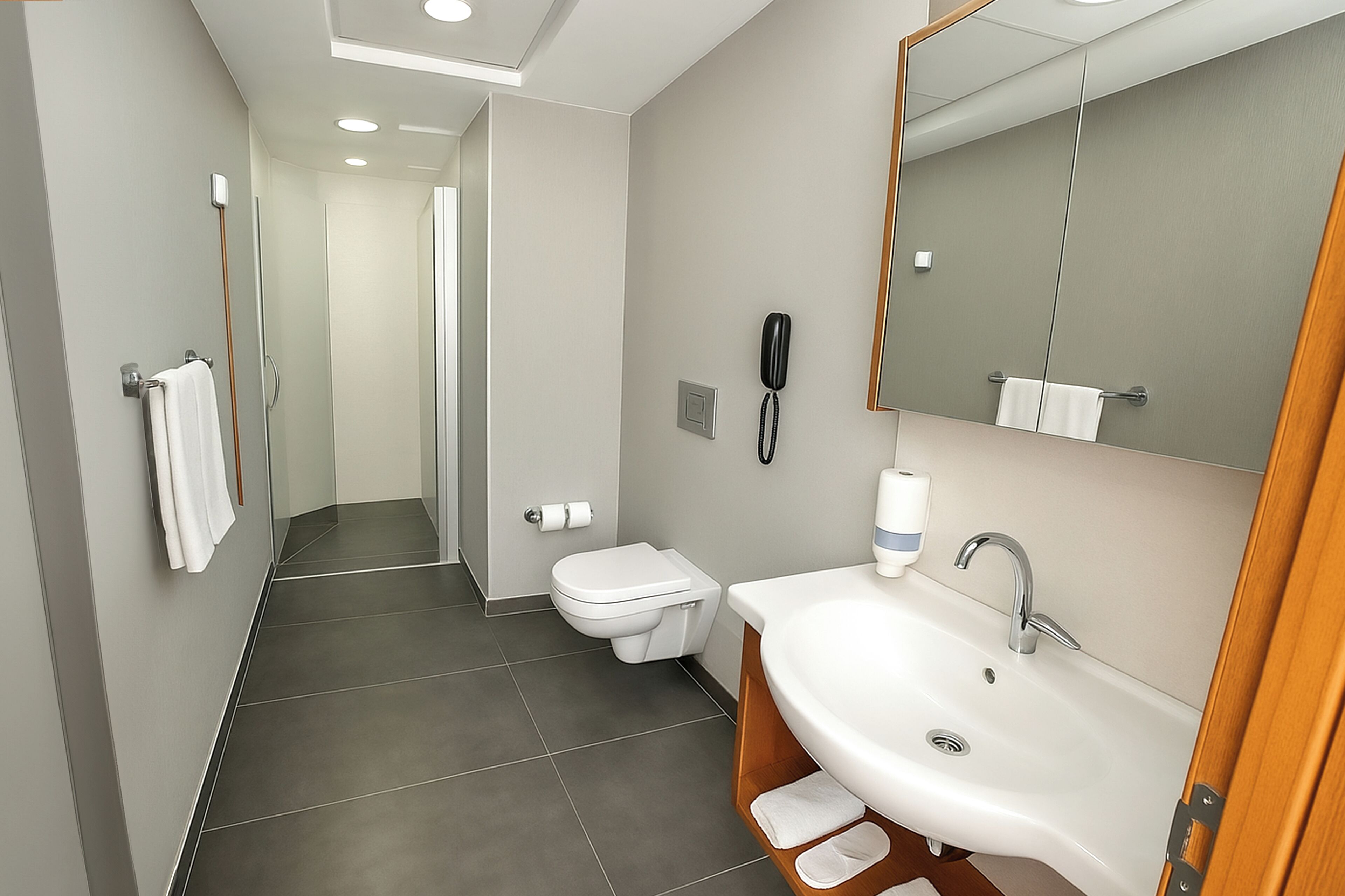 A modern bathroom with a white sink, mirror, and toilet.