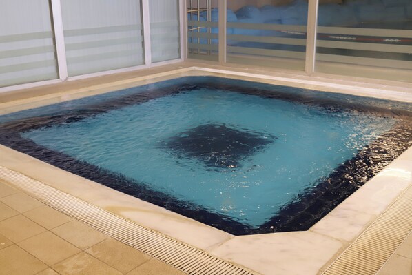 Relax in a hot tub surrounded by a secure, patterned floor.