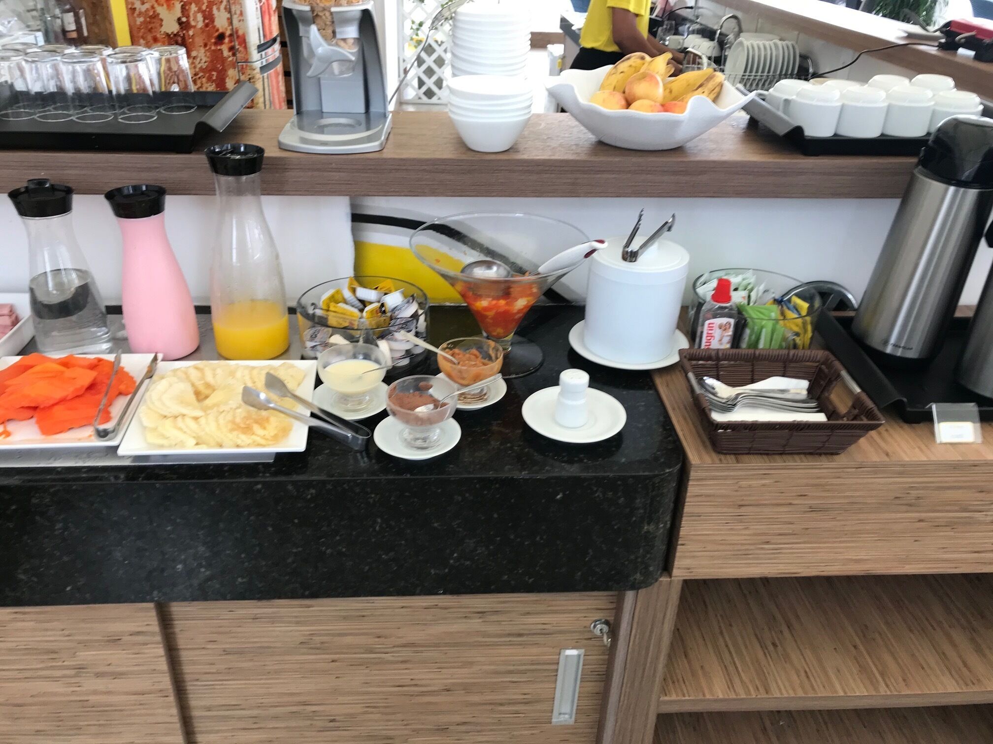 A breakfast buffet with various food items and condiments.
