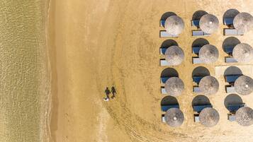 On the beach, sun-loungers, beach umbrellas, beach towels