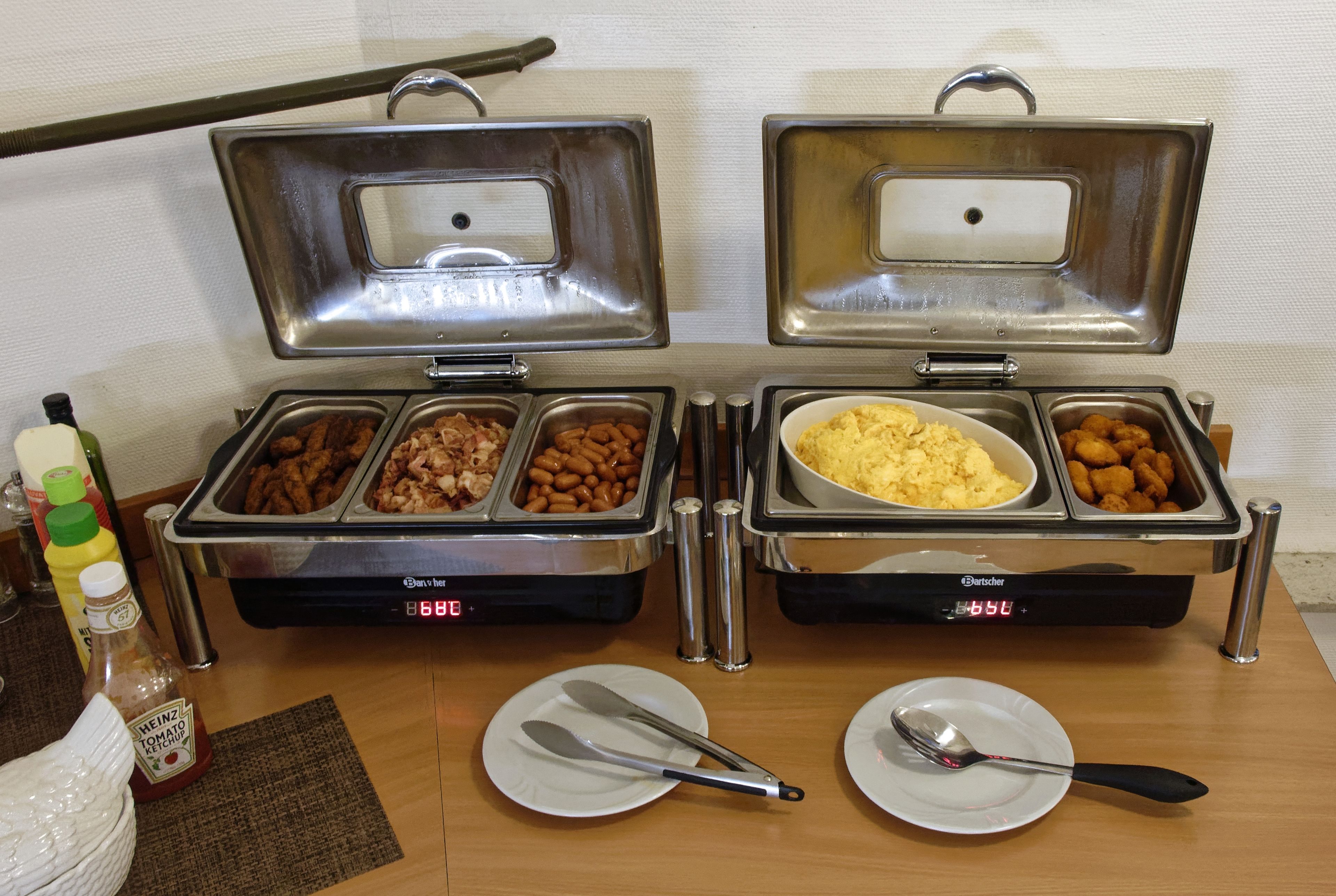 Two buffet stations with various food options and condiments.