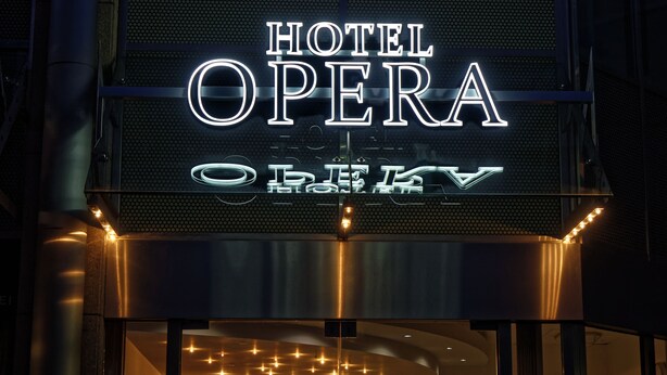 A neon sign for "HOTEL OPERA" with a modern, industrial design. - Opera Hotel Köln (Cologne)
