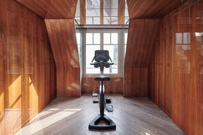 A room with a wooden interior, a ceiling fan, and a window with a view.