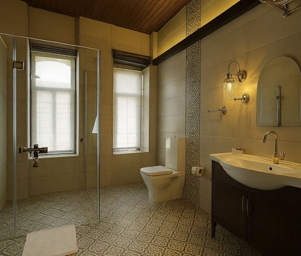 A modern bathroom with a glass shower enclosure, a toilet, and a vanity with a large mirror.