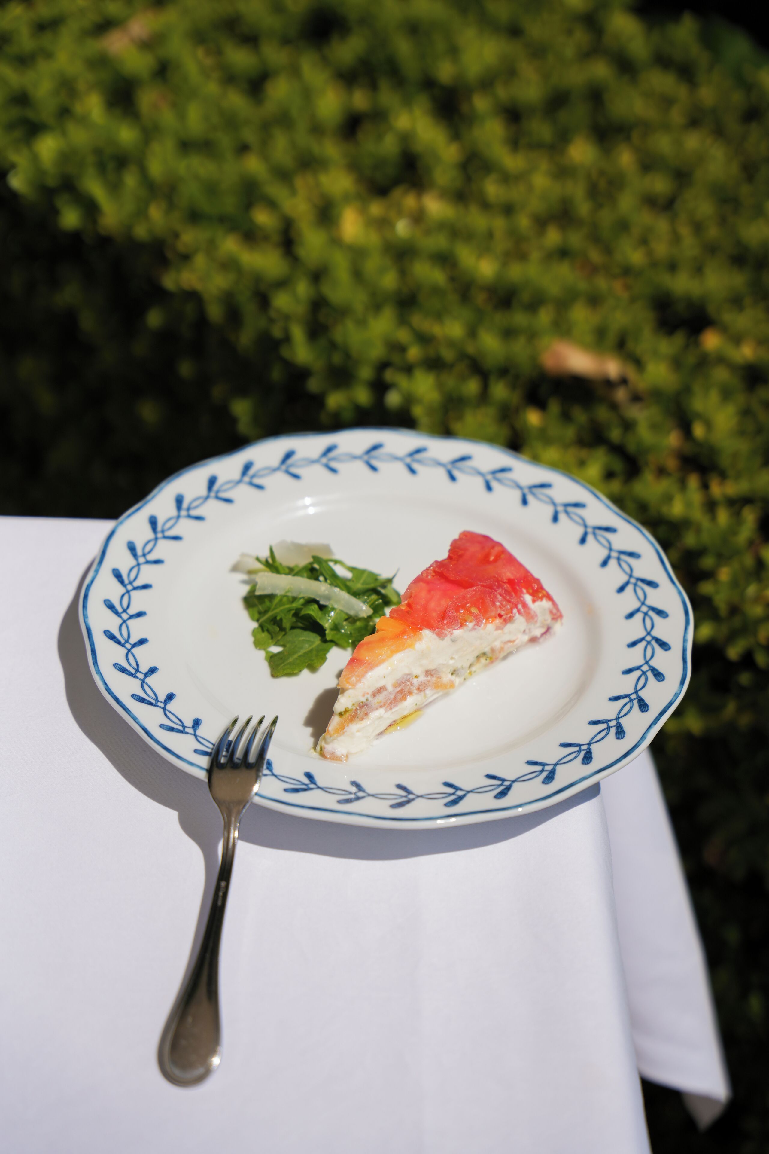 A plate with a slice of pie and a fork on a table.