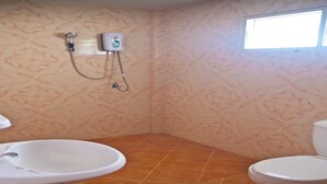 A bathroom with a sink, toilet, shower, and a window. - Orchid Homestay Buriram No2 (Phlapphlachai)