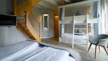 Una habitación con una cama litera, una silla, una escalera de madera y un televisor de pantalla plana.