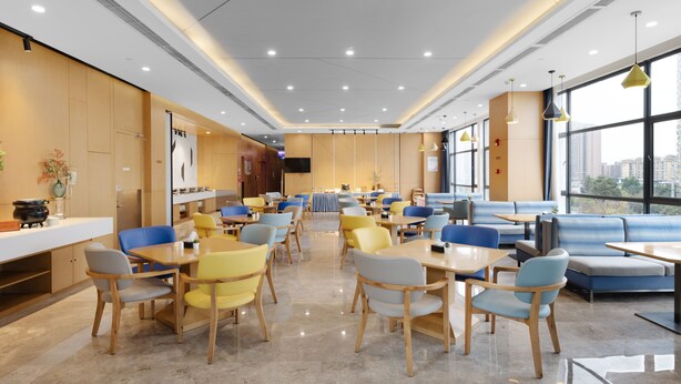 A modern dining area with multiple tables and chairs, large windows, and a clean, well-lit interior. - Holiday Inn Express Chengdu Xindu by IHG (Chengdu)