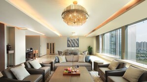 A modern living room with a large chandelier, a dining area, and a view of the city. - Intercontinental Taiyuan by IHG (Taiyuan)