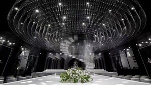 A grand hall with a high ceiling adorned with sparkling lights, a central floral arrangement, and tiered seating. - Intercontinental Taiyuan by IHG (Taiyuan)