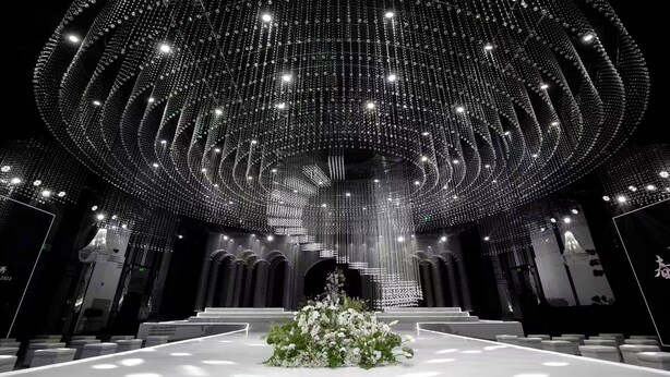 A grand hall with a high ceiling adorned with sparkling lights, a central floral arrangement, and tiered seating. - Intercontinental Taiyuan by IHG (Taiyuan)