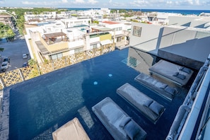 Outdoor pool, open 9:00 AM to 9:00 PM, pool loungers