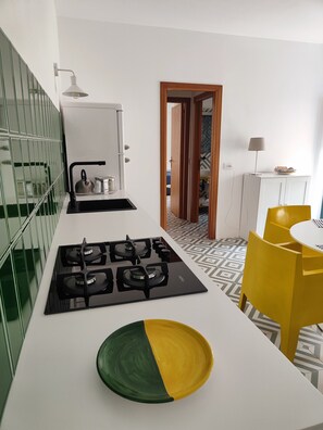 Fridge, stovetop, dishwasher, coffee/tea maker