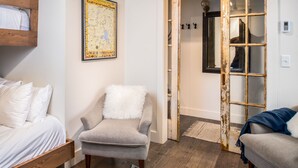 A room with a bed, a chair, a rug, and a map on the wall. - Outpost: Pitchfork 2303 - Close to Snow King Mtn! (Jackson)