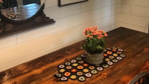 A kitchen with a wooden countertop, a mirror, a framed quote on the wall, and a potted plant. - Snowgoose Pond Bed & Breakfast (Palmer)