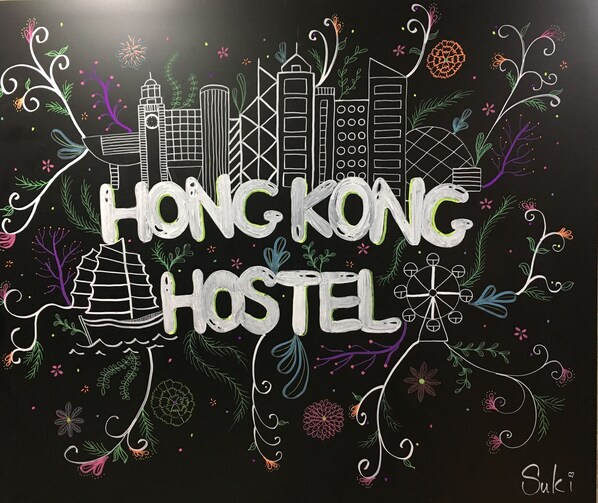 A blackboard with "Hong Kong Hostel" written in white chalk, surrounded by various doodles and sketches. - Hong Kong Hostel (Kowloon)