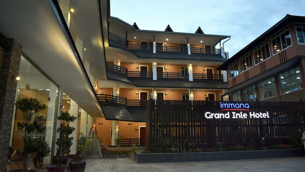 The Grand Inle Hotel with a multi-story structure, balconies, and a well-lit entrance. - Immana Grand Inle Hotel (Nyaungshwe)