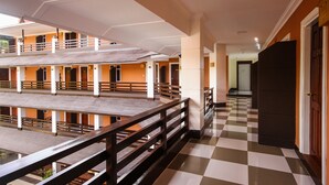 A hotel with a checkered floor, multiple balconies, and a wooden railing. - Immana Grand Inle Hotel (Nyaungshwe)