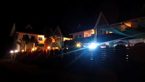 A building with multiple balconies and a well-lit facade at night. - Peace Pool Resort (Khun Han)