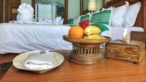 A hotel room with a neatly made bed, a fruit bowl on the table, and a folded towel. - Nyaung Shwe City Hotel (Nyaungshwe)