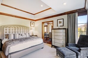 A bedroom with a large bed, a dresser, a chair, and a desk. - Chic 2 BR+Den Ritz-Carlton Condo with Valley Views by RedAwning - Save 20% on 7+ Nights! (Vail)