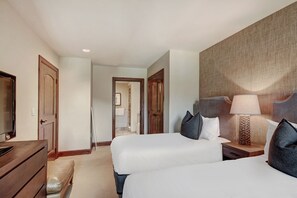 A hotel room with two beds, a wooden dresser, a TV, and a lamp. - 2BR Residence at the Ritz-Carlton with Valley View by RedAwning - Save 20% on 7+ Nights! (Vail)
