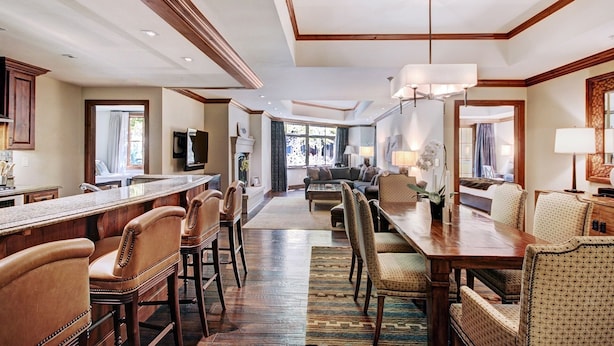 A spacious hotel lobby with a long dining table, comfortable seating, and a modern ceiling design. - Luxe 2BR+Den Ritz-Carlton Residence Quiet Location by RedAwning (Vail)