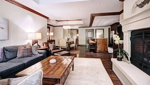 A spacious living room with a fireplace, a dining area, and a kitchen. - Luxe 2BR+Den Ritz-Carlton Residence Quiet Location by RedAwning (Vail)
