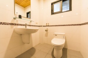A bathroom with a white sink, a toilet, and a mirror above the sink. - Ting Shuan B.B Hostel (Suao)