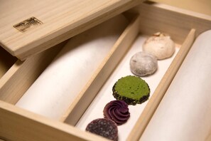 A wooden box with compartments containing various food items.