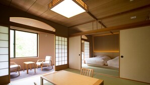 A traditional Japanese room with tatami flooring, a low wooden table, and sliding doors. - Kuriyasuizan (Sapporo)