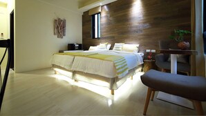 A modern bedroom with a large bed, bedside tables, a chair, and a small table with a plant. - Manor Le Rayon Vert (Ji'an)