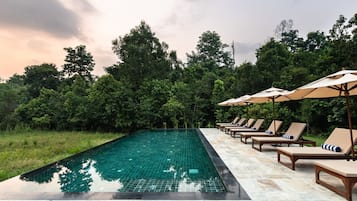 Alberca al aire libre por temporada y sombrillas en la alberca