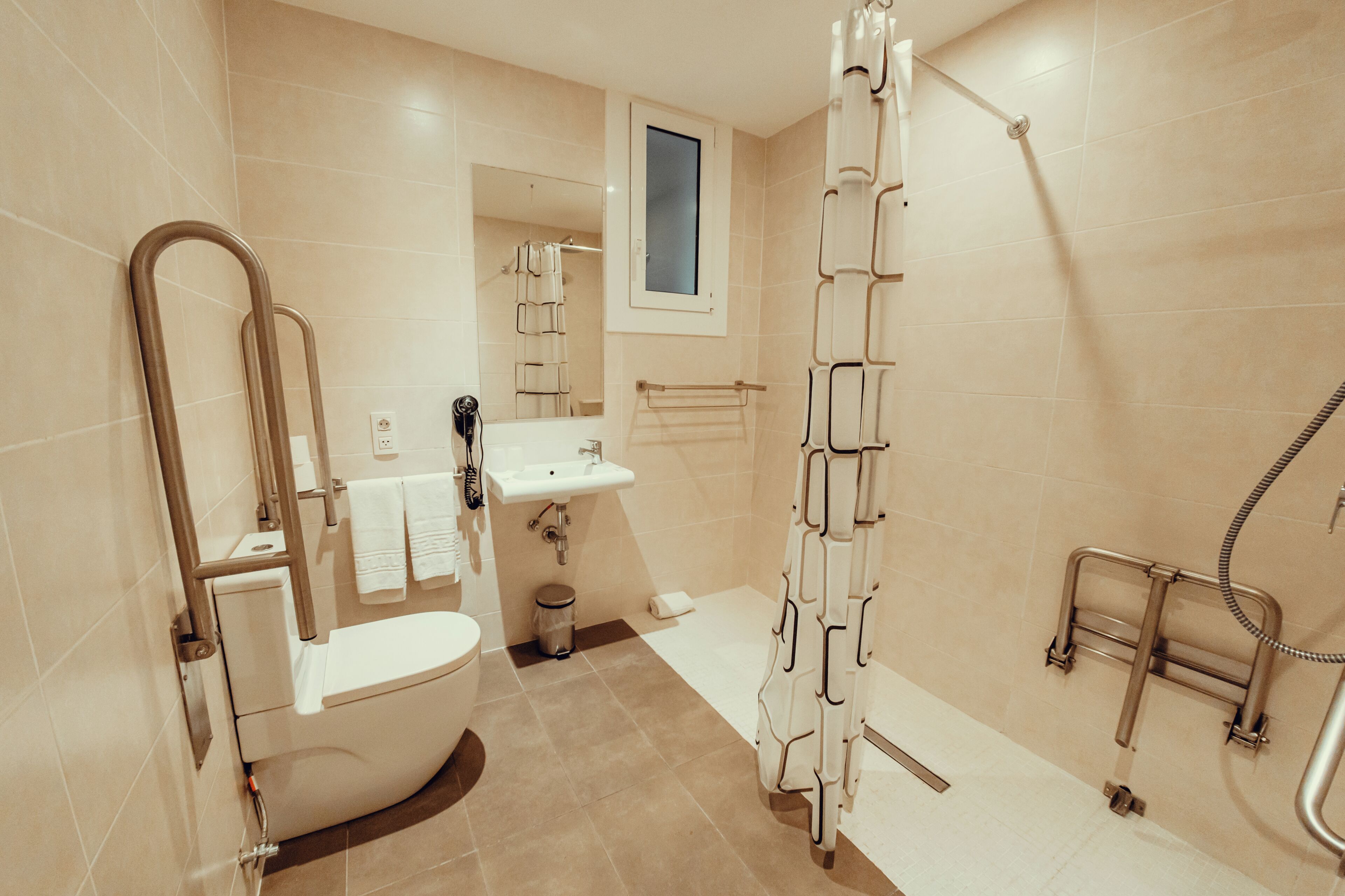 Un baño moderno con inodoro, lavamanos y ducha.