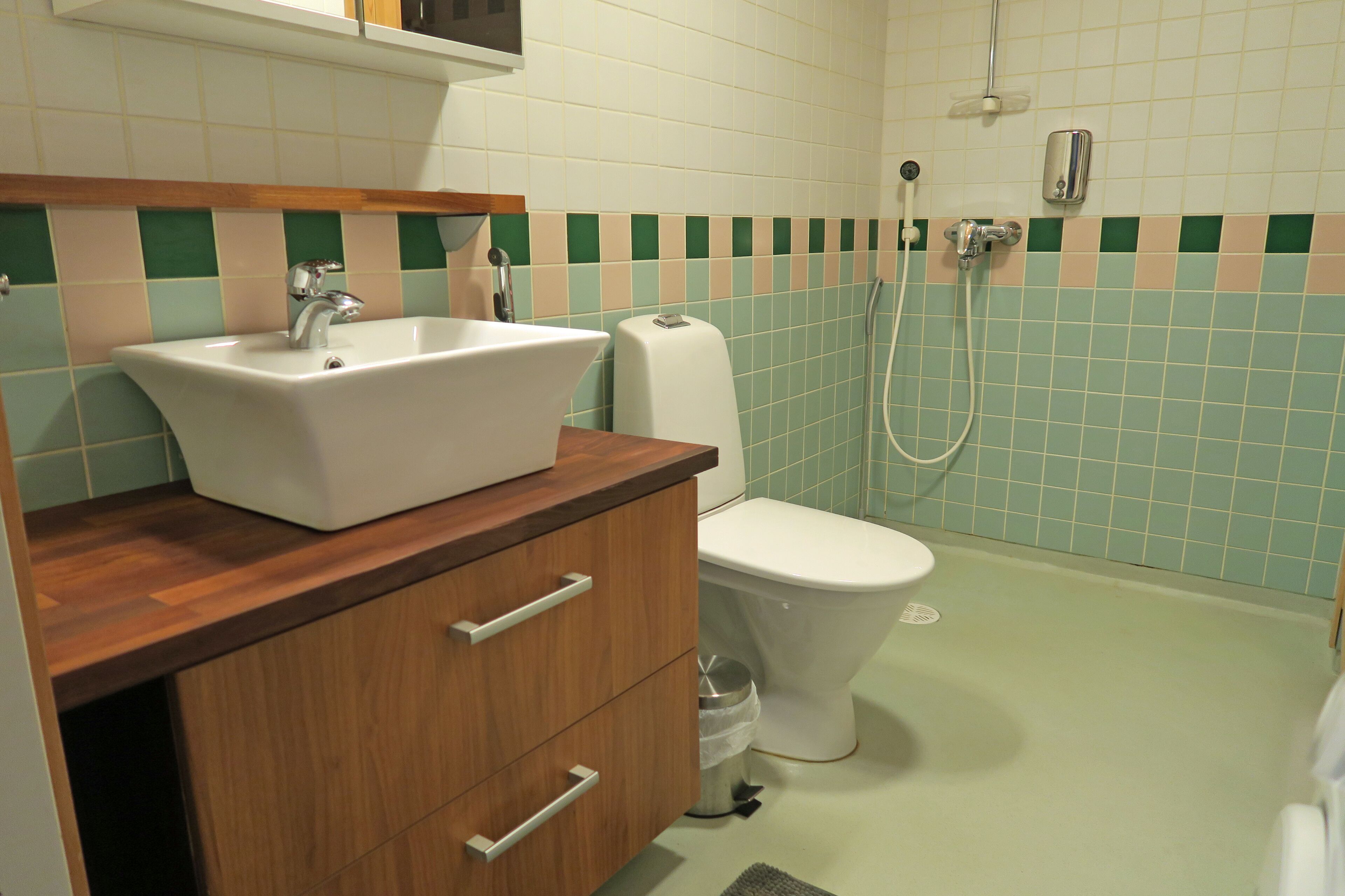 A bathroom with a sink, toilet, and shower.
