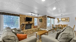 A spacious living room with a fireplace, comfortable seating, and a television. - The Lift C112 (Breckenridge)