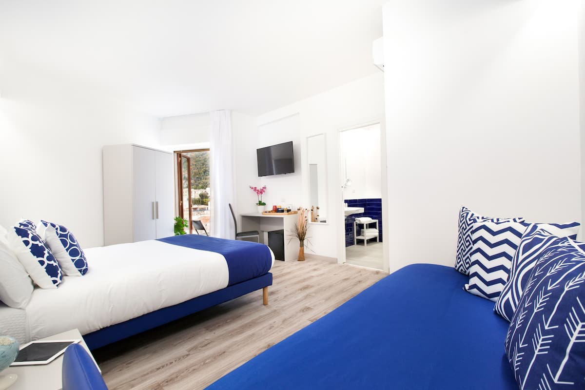 Junior Triple Room | Minibar, in-room safe, desk, laptop workspace