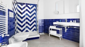 A modern bathroom with a shower, toilet, and sink.