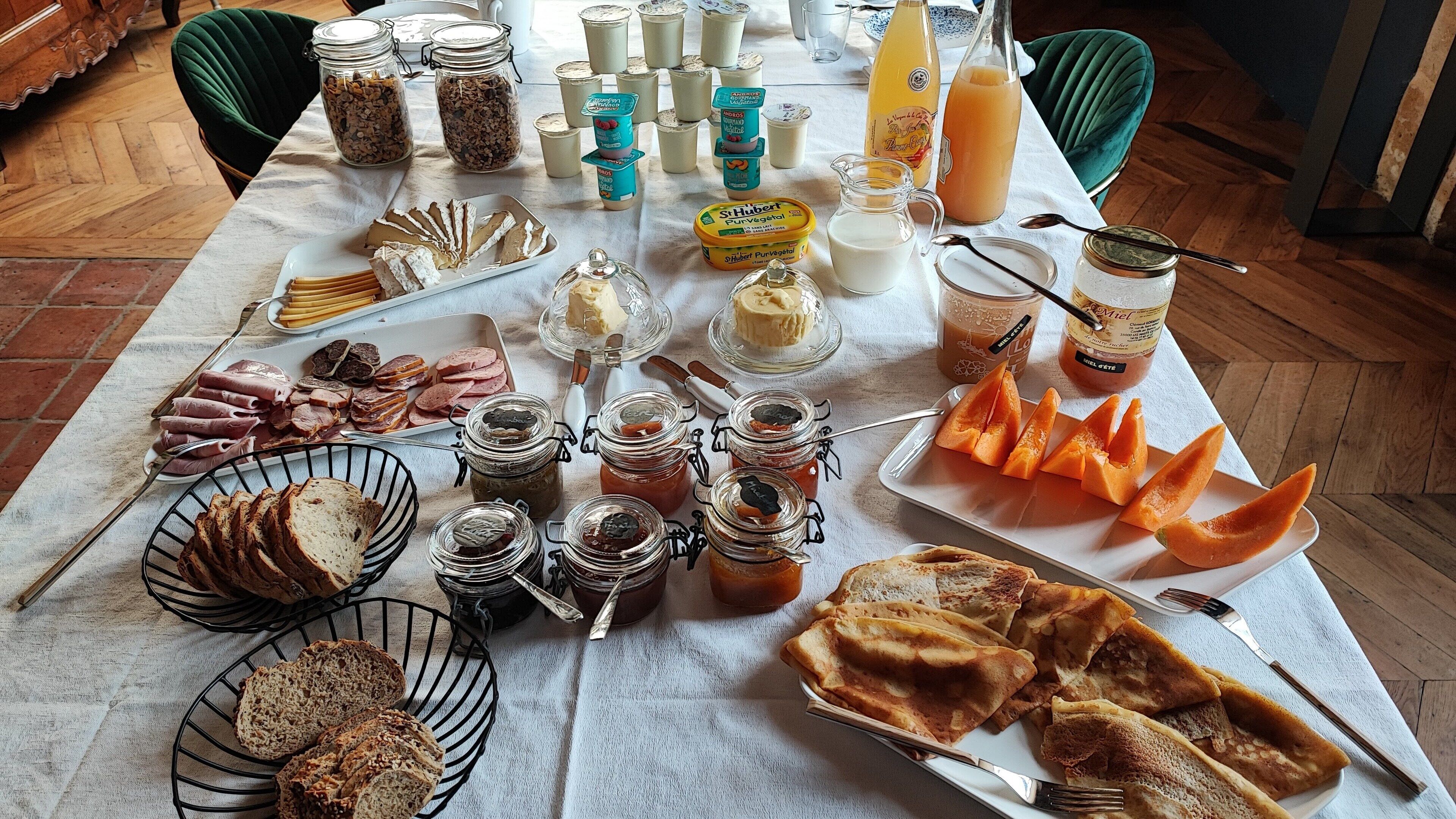 A breakfast buffet with various food items and beverages.