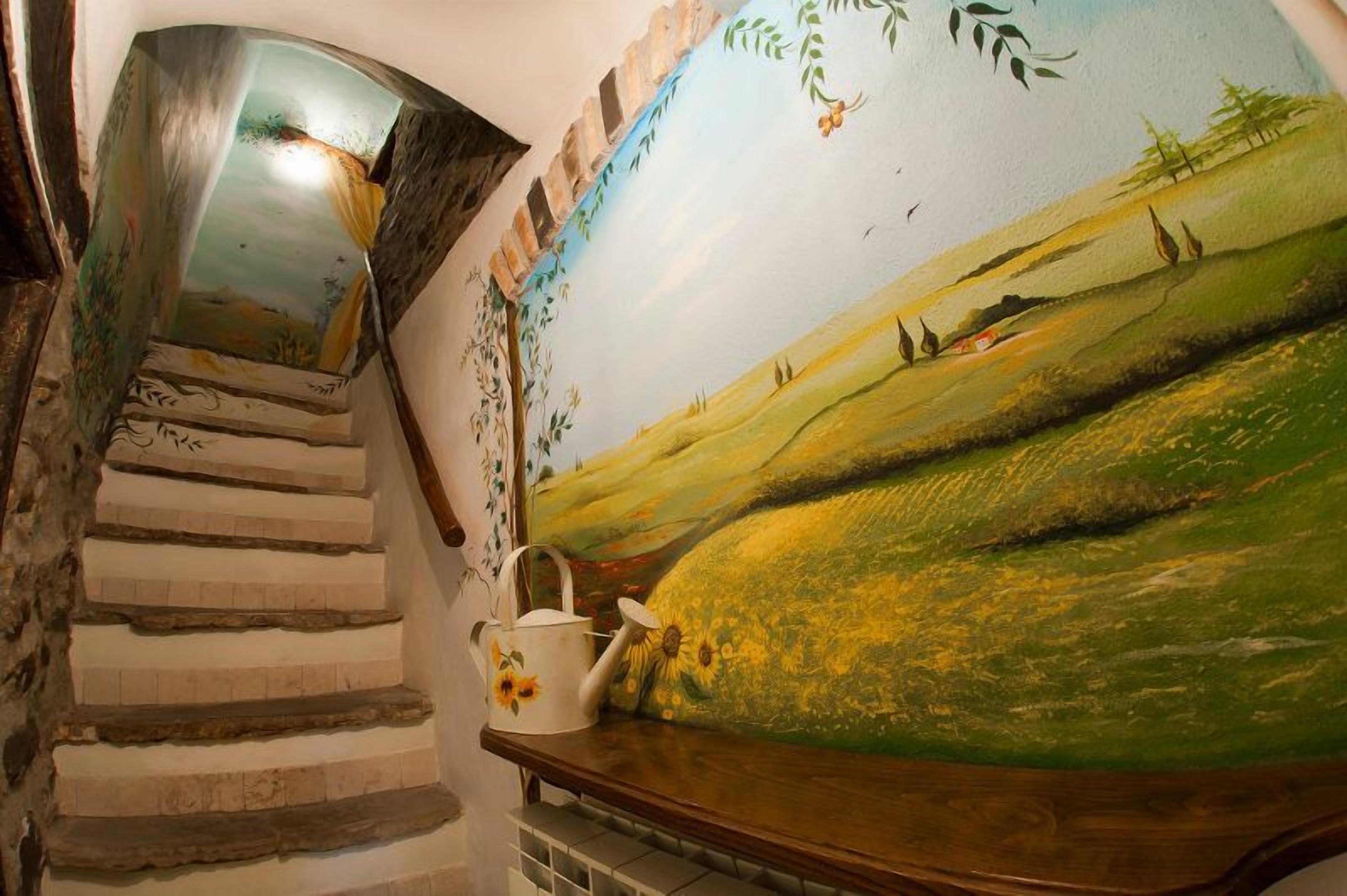 A staircase with a rustic design, a mural of a landscape, and a white watering can on a wooden ledge.