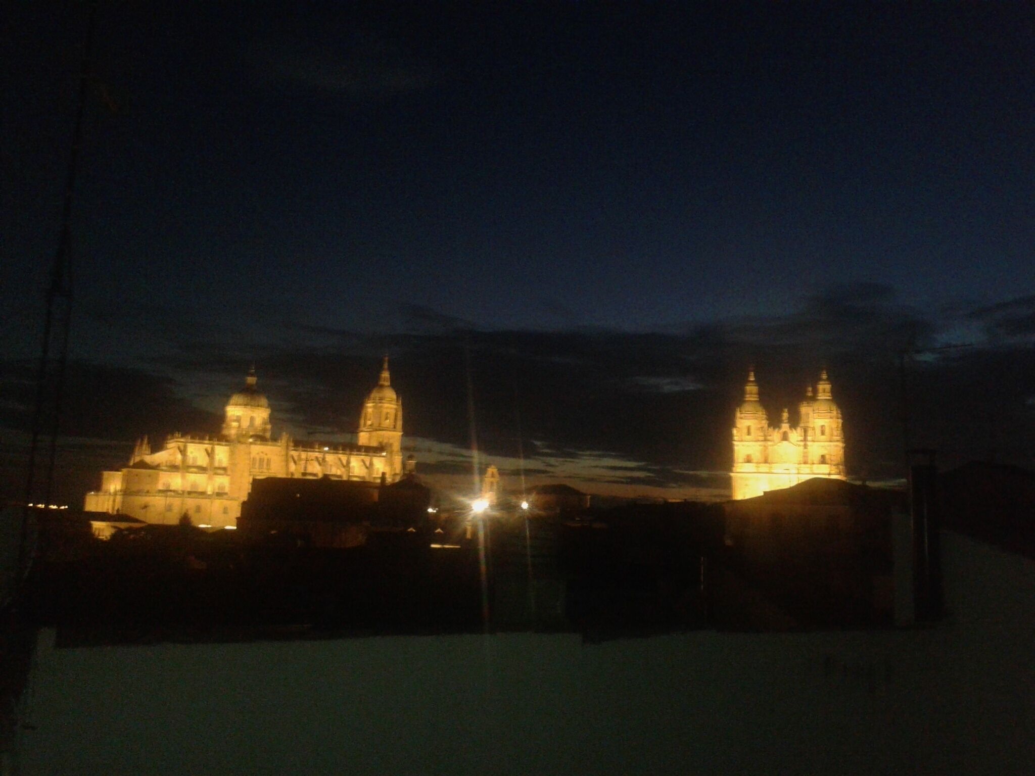 A large, illuminated cathedral with two prominent towers, surrounded by a snowy landscape.