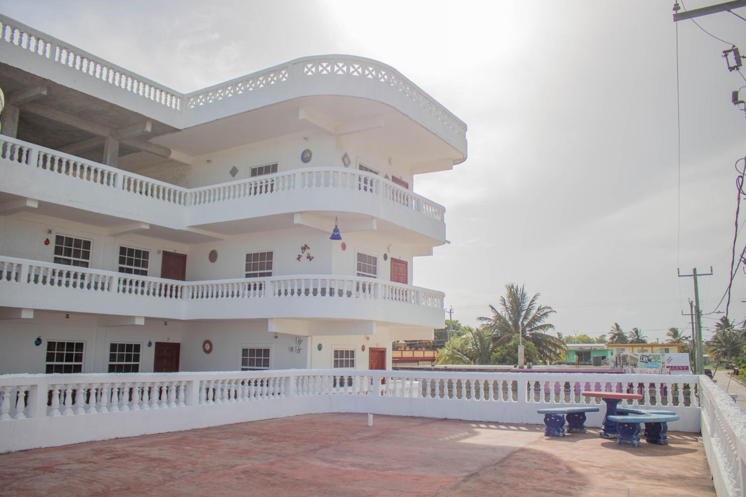 A multi-story building with balconies and a courtyard.